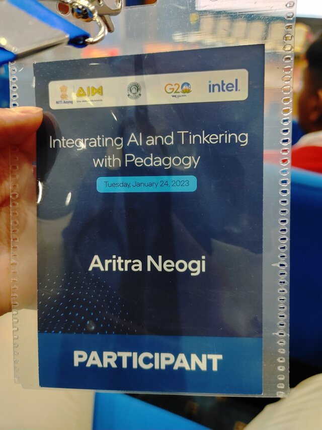 Aritra Neogi holding the AIoT Showcase identity card