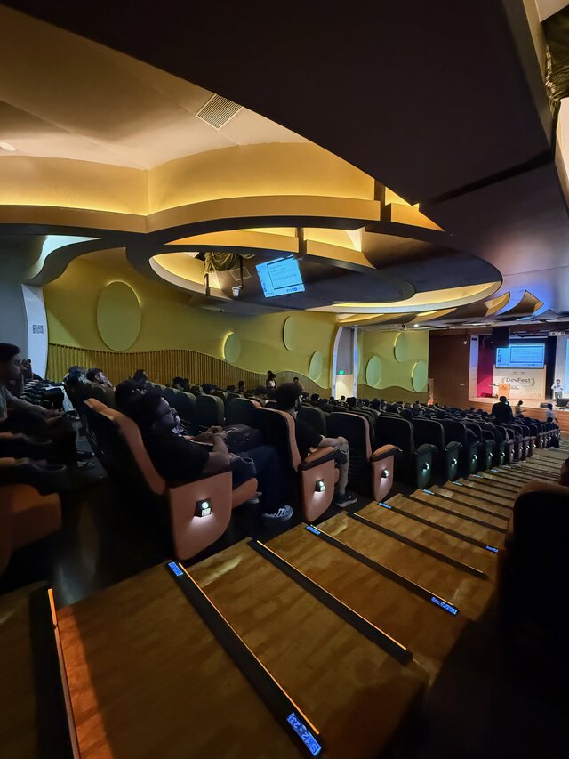 Aritra Neogi attending speaker sessions in main hall